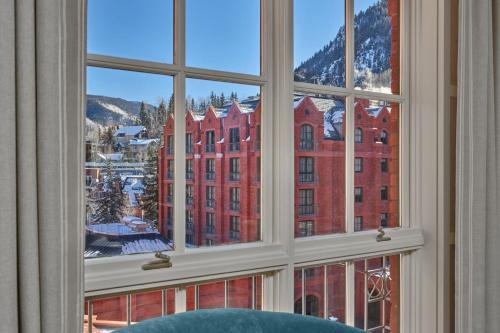 a window with a view of a red building at St. Regis Aspen Resort in Aspen