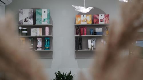 two shelves on a wall with books at HIDE PARK Hotel in Vinnytsya