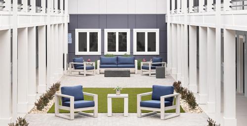 a group of chairs and tables in a building at stayAPT Suites Madison-Greenbrier in Madison