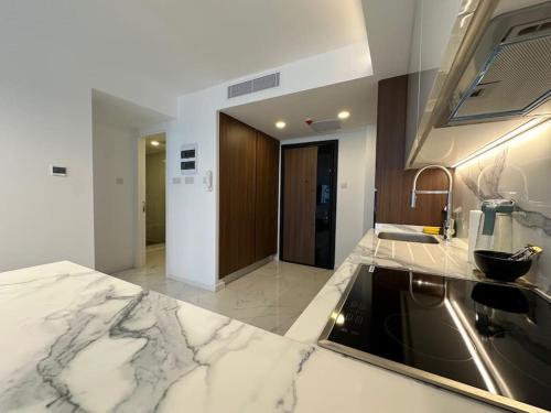 a kitchen with marble counter tops and a sink at Grand Sapphire B-174 Luxury Residence By MyGuest Cyprus in Iskele