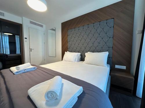 a bedroom with a large bed with towels on it at Grand Sapphire B-174 Luxury Residence By MyGuest Cyprus in Iskele