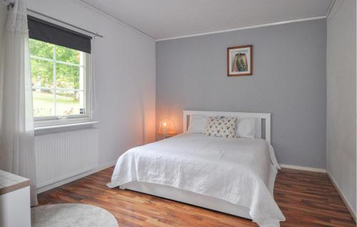 a bedroom with a white bed and a window at Stunning Home In Degerfors With Sauna in Degerfors