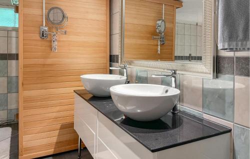 a bathroom with two white sinks on a counter at Stunning Home In Degerfors With Sauna in Degerfors