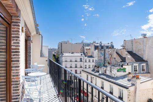 a balcony with a view of a city at FRATERNiTY-HOTEL in Paris