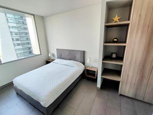 a bedroom with a bed and a star on a shelf at Luxurious High-Rise HS WiFi, amazing city views in Mexico City