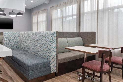 a living room with a couch and a table at Hampton Inn Saline in Saline