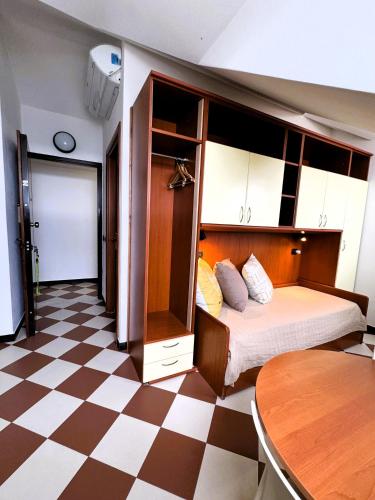 a bedroom with a bed and a checkered floor at Giada in Moneglia