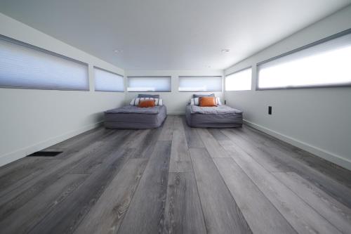 a room with two couches in a room with wood floors at Red Rock RV Park in Island Park