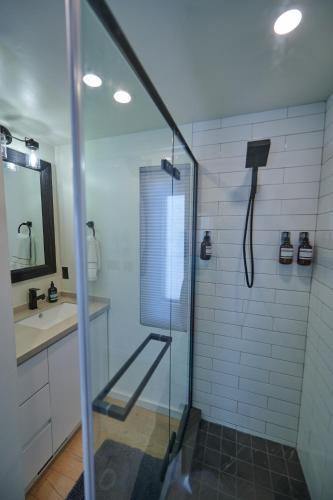 a shower with a glass door in a bathroom at Red Rock RV Park in Island Park