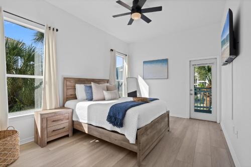 a bedroom with a bed and a ceiling fan at Seas The Day in Navarre