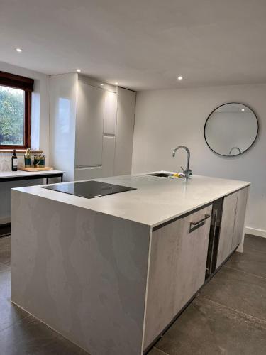 a kitchen with a sink and a counter top at Oak Barn-ideal for Nec,Hs2,BHX,family gatherings in Birmingham