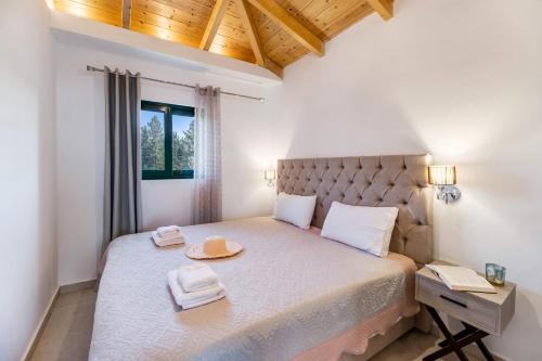 a bedroom with a bed with a hat on it at Gkountis Deluxe King Suite 2 in Tsoukaladhes