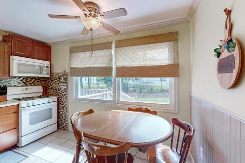 a kitchen with a table and a ceiling fan at York Home Away from Home in York