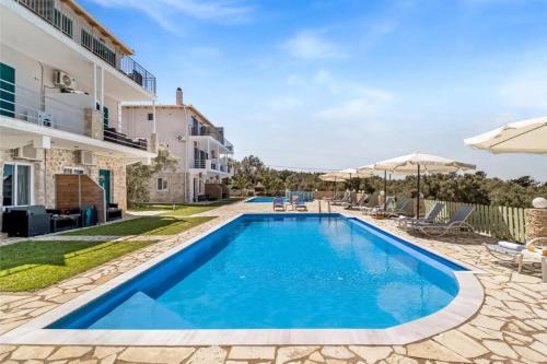 a swimming pool in the backyard of a villa at Gkountis Deluxe Studio in Tsoukaladhes