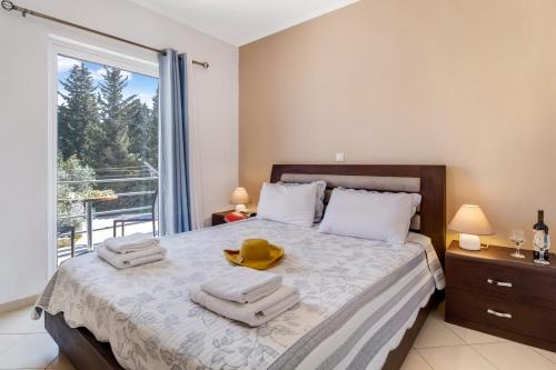 a bedroom with a bed with towels on it at Gkountis deluxe apartment in Tsoukaladhes