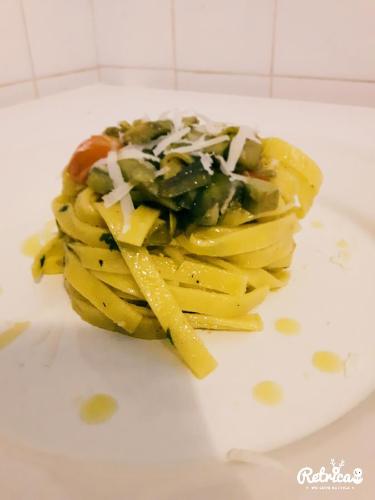 a plate of pasta with sauce and cheese on it at Agriturismo Santa Giusta in Poggio San Lorenzo