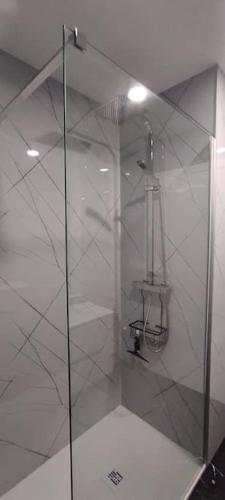 a shower with a glass door in a bathroom at Casa da Barroca - Piscina Exclusiva & Natureza in Arcos de Valdevez