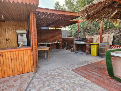 an outdoor patio with a table and a bench at Ckausama North in San Pedro de Atacama