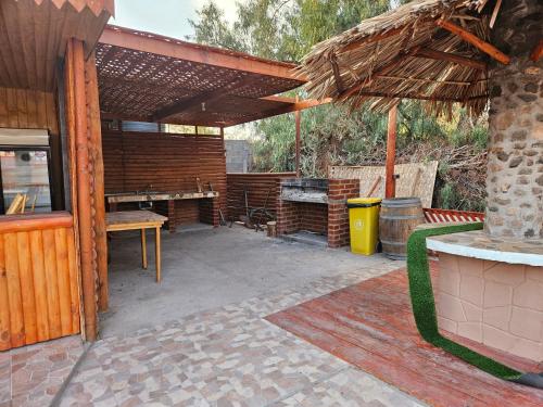an outdoor patio with a grill and an umbrella at Ckausama North in San Pedro de Atacama