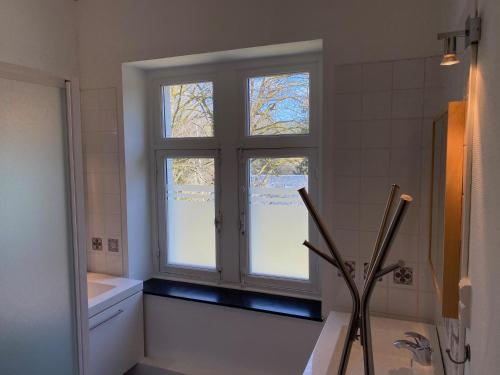 a bathroom with a window and a tub and a sink at Le Clos des Tilleuls - Gîte de Charme avec Piscine au Cœur de la Nature in Libin