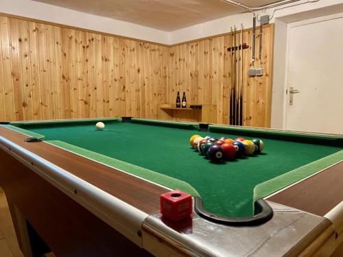 a pool table with balls on it in a room at Le Clos des Tilleuls - Gîte de Charme avec Piscine au Cœur de la Nature in Libin