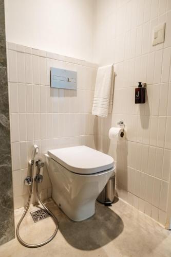 a bathroom with a toilet with a hose at Vain Boutique Hotel in Buenos Aires