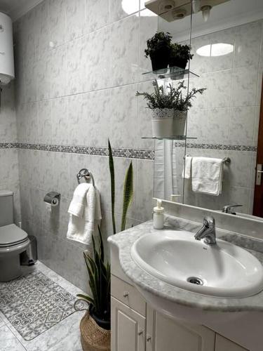 a bathroom with a sink and a toilet at Casa Paquitina in Costa Teguise
