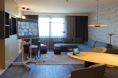 a living room with a couch and a table at Frankfurt Airport Marriott Hotel in Frankfurt/Main