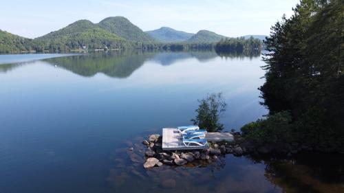 a picnic table in the middle of a lake at Suite with mountains view & Resort access in Lac-Superieur