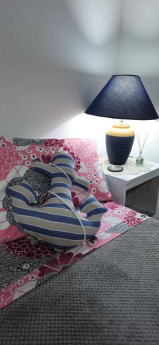 a bed with a pillow and a lamp on a table at Via Roma 55 in Lipari