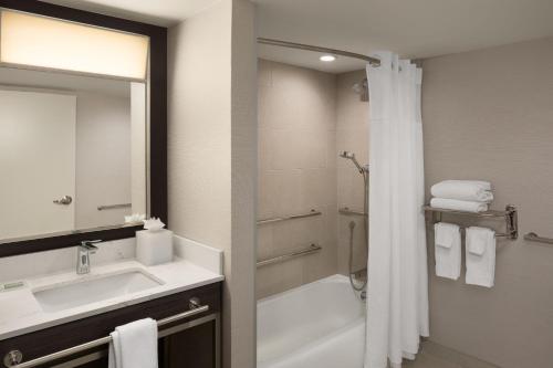 a bathroom with a sink and a shower and a mirror at Courtyard New Haven at Yale in New Haven