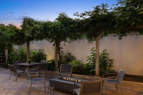 a patio with a table and chairs and a fire pit at Courtyard New Haven at Yale in New Haven
