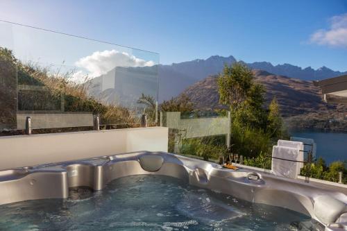 a pool of water with a view of a mountain at Alpine Edge Villa- AC- Free Parking- Hot Tub- BBQ in Queenstown