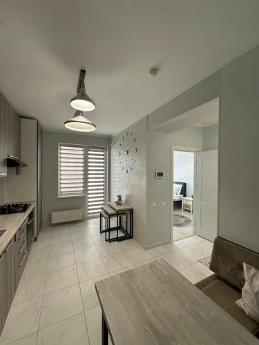 a large kitchen with a table in a room at ApartDirect Botanica 1 in Chişinău