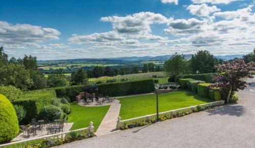 a garden with a view of the hills at Roundthorn Country House & Luxury Apartments in Penrith