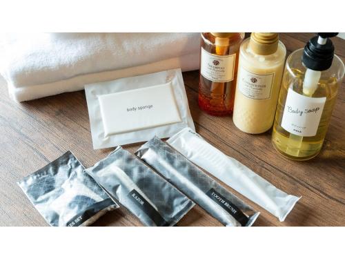 a table topped with bottles of essential oils and cosmetics at HOTEL Progress inn Nago MATABee - Vacation STAY 01594v in Nago