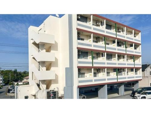 a white building with balconies on the side of it at HOTEL Progress inn Nago MATABee - Vacation STAY 01594v in Nago