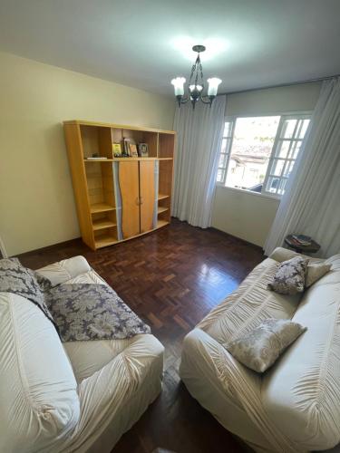 a living room with two beds and a window at Casarão DM in Domingos Martins