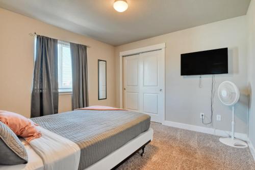 a bedroom with a bed and a flat screen tv at Family friendly 5bd3bath 3CarGarage GameRoom in Cimarron Hills
