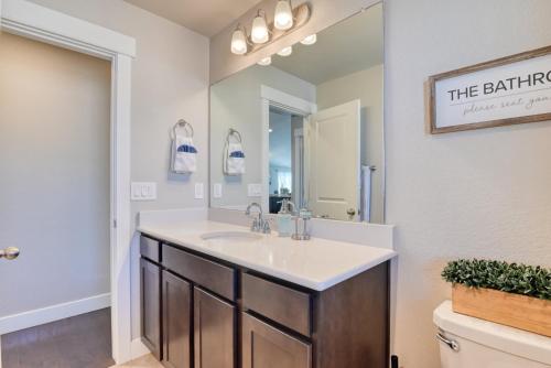 a bathroom with a sink and a mirror at Family friendly 5bd3bath 3CarGarage GameRoom in Cimarron Hills