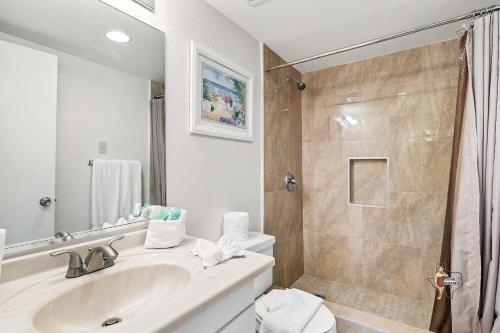 a bathroom with a sink and a shower at Bahia Mar Solare Beachfront Resort Condos with Two Pools in South Padre Island