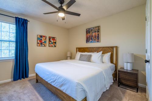 a bedroom with a bed and a ceiling fan at Affordable 4-Bedroom Retreat Near DT Cartersville in Cartersville