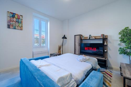 a living room with a bed and a tv at 1-BR Monaco Apartment - 1 minute to Monaco in Beausoleil