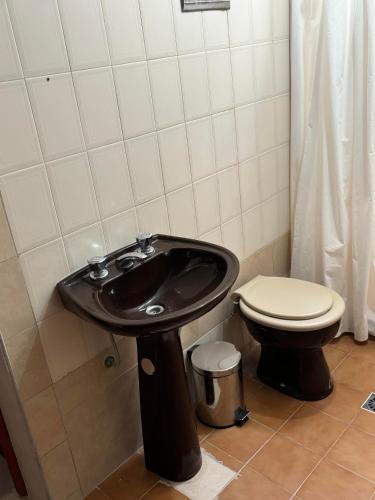 a bathroom with a black sink and a toilet at CHACRAS Land in Ciudad Lujan de Cuyo