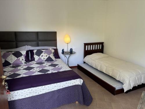 a bedroom with two beds and a table with a lamp at CHACRAS Land in Ciudad Lujan de Cuyo