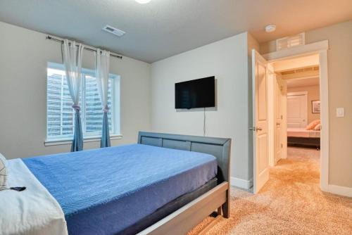 a bedroom with a bed and a flat screen tv at Family friendly 5bd3bath 3CarGarage GameRoom in Cimarron Hills