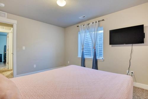 a bedroom with a bed and a flat screen tv at Family friendly 5bd3bath 3CarGarage GameRoom in Cimarron Hills