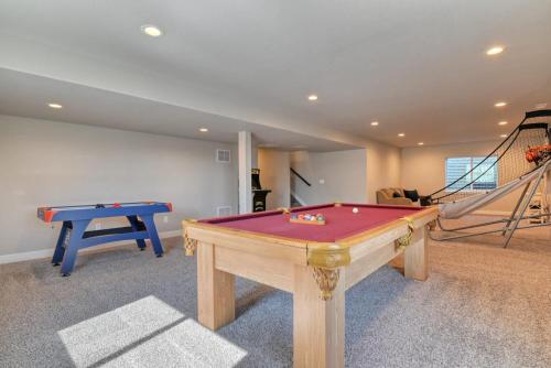 a living room with a pool table and a staircase at Family friendly 5bd3bath 3CarGarage GameRoom in Cimarron Hills