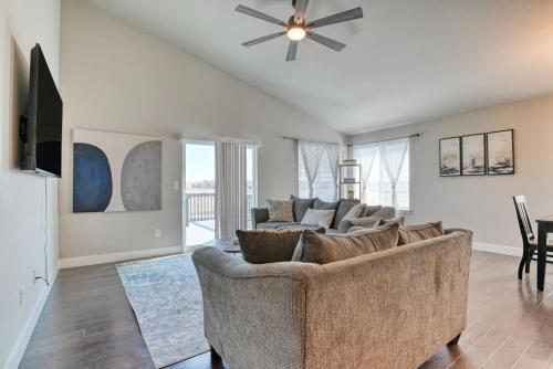 a living room with a couch and a ceiling fan at Family friendly 5bd3bath 3CarGarage GameRoom in Cimarron Hills