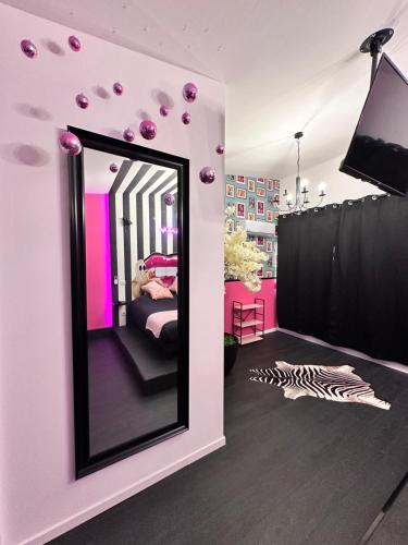 a room with a mirror and a zebra at Maison 60 m2 Loveroom romantique avec jacuzzi privé à 10 min de Nancy et jardin privé in Messein
